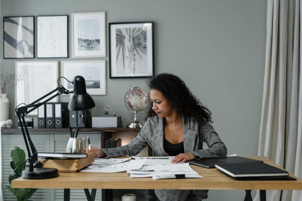 electrician reviewing certification documents and meter on desk