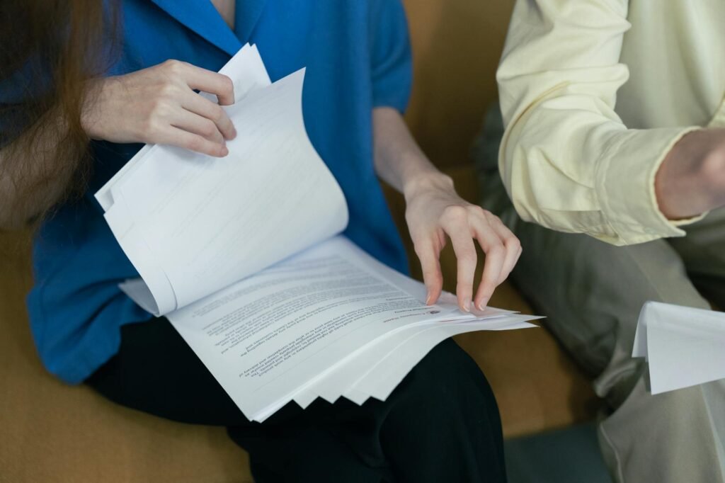 electrician reviewing electrical certification documents and blueprints on a desk