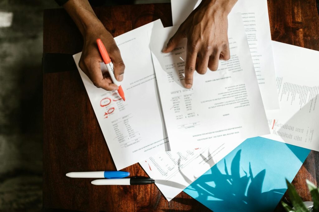 electrician reviewing electrical certification documents and meter installation paperwork on a work desk